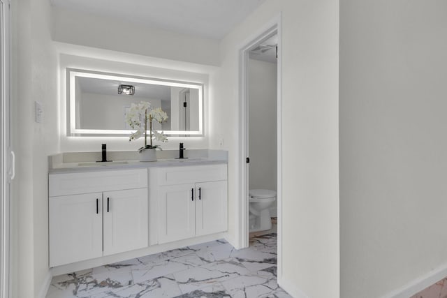 bathroom featuring vanity and toilet