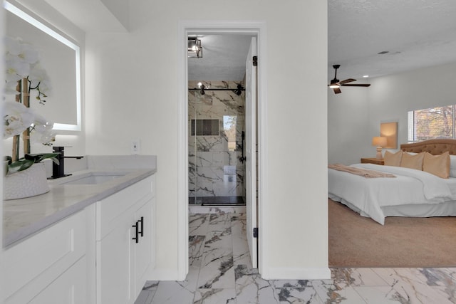 bathroom featuring ceiling fan, vanity, and a shower with shower door