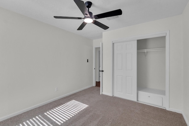 unfurnished bedroom featuring a closet, ceiling fan, and light colored carpet