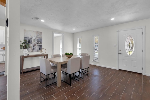 dining space featuring a textured ceiling