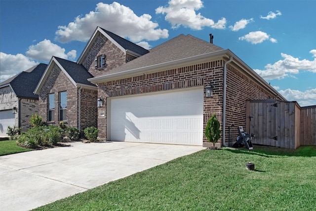 view of side of property featuring a garage and a yard