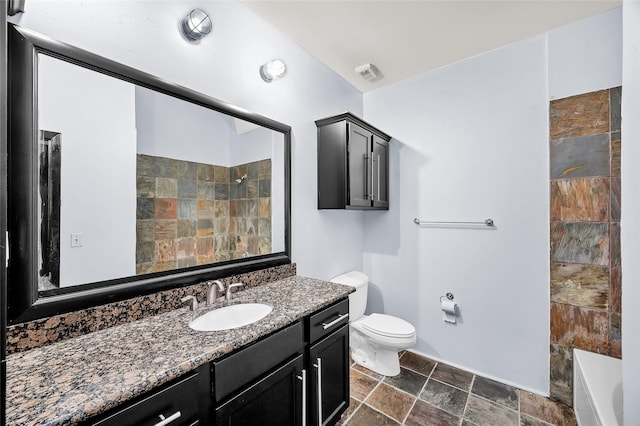 bathroom featuring a shower, vanity, and toilet