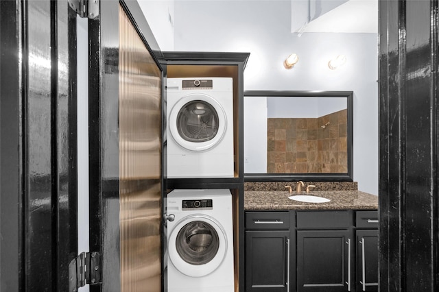 clothes washing area featuring stacked washer / dryer and sink