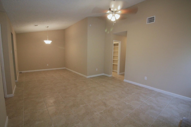 unfurnished room with a textured ceiling, vaulted ceiling, and ceiling fan