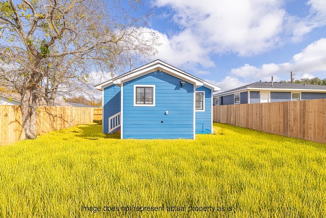 rear view of house with a lawn