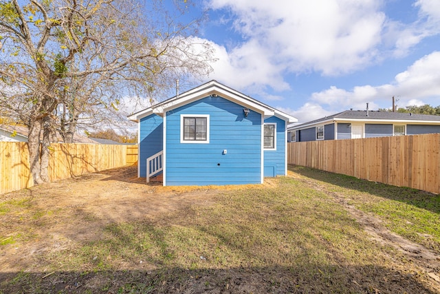 rear view of house featuring a yard