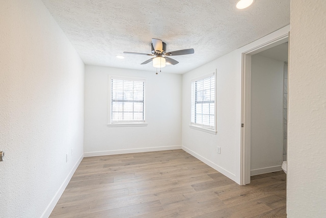 unfurnished room with ceiling fan, a textured ceiling, and light hardwood / wood-style flooring