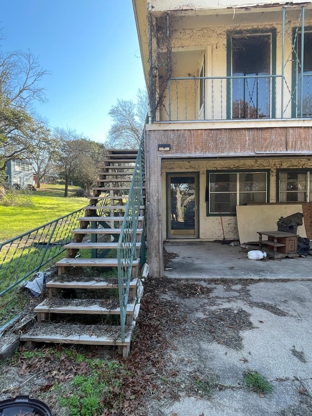 view of exterior entry with a balcony