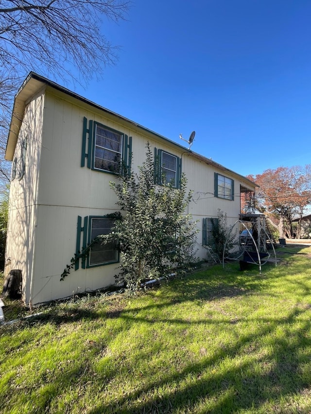 rear view of house featuring a lawn