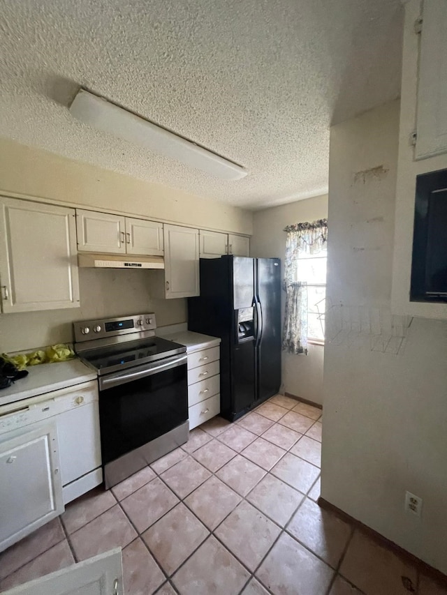 kitchen featuring black fridge, light tile patterned flooring, stainless steel range with electric cooktop, a textured ceiling, and white cabinets