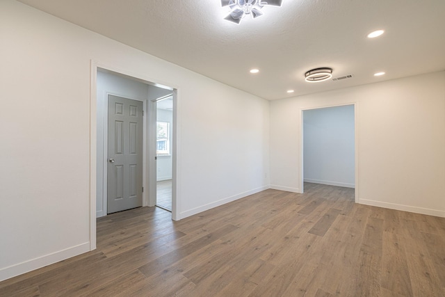 empty room with hardwood / wood-style floors