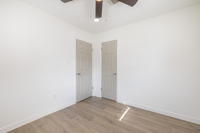 spare room with ceiling fan and light hardwood / wood-style flooring