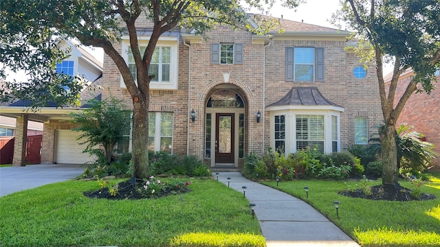 6114 Sienna Arbor Ln, Houston, TX 77041 - view of front facade with brick siding, fence, a front yard, concrete driveway, and an attached garage
