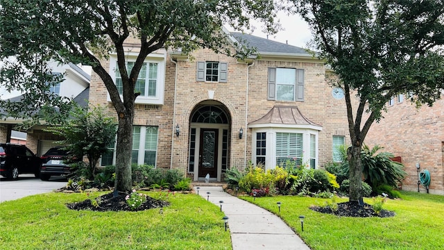6114 Sienna Arbor Ln, Houston, TX 77041 - view of front facade featuring a front lawn, a garage, and brick siding