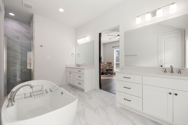 bathroom with vanity, ceiling fan, and plus walk in shower