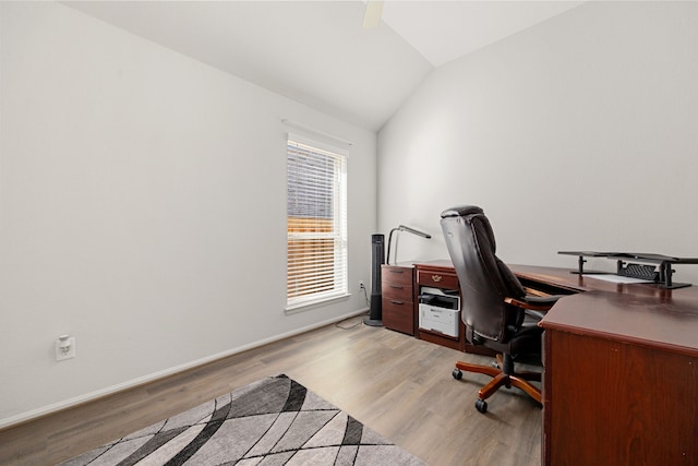 office space featuring light wood-type flooring and vaulted ceiling