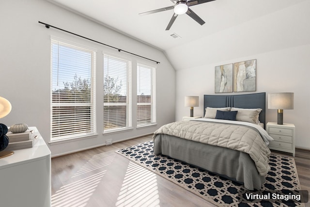 bedroom featuring hardwood / wood-style floors, ceiling fan, and vaulted ceiling