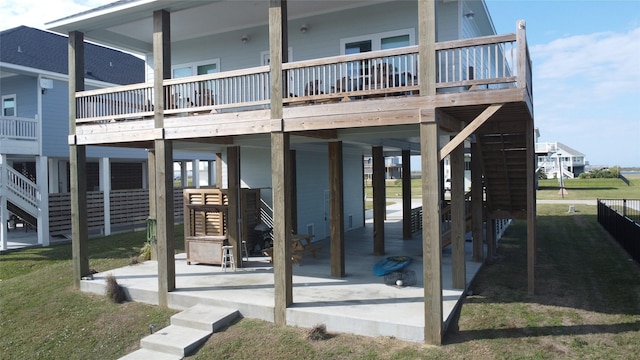 rear view of house with a patio area and a wooden deck