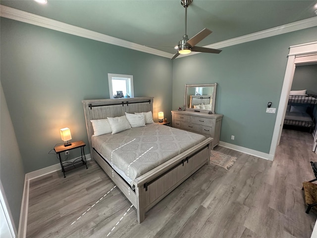 bedroom with ceiling fan, light wood-type flooring, and crown molding