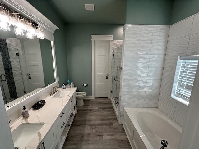 full bathroom with vanity, toilet, wood-type flooring, and independent shower and bath