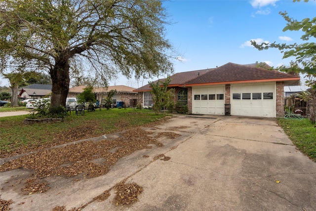 ranch-style home with a front lawn and a garage