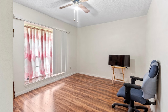 interior space with hardwood / wood-style flooring, plenty of natural light, ceiling fan, and a textured ceiling