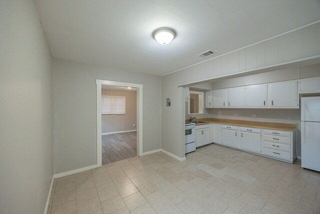1202 14th Ave N, Texas City, TX 77590 - kitchen with white cabinetry, sink, and white appliances
