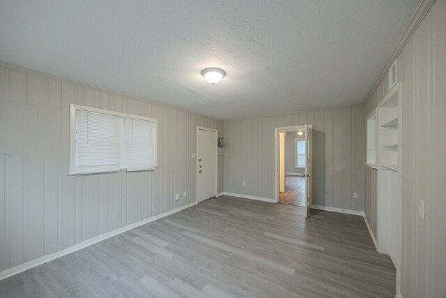 1202 14th Ave N, Texas City, TX 77590 - empty room featuring light hardwood / wood-style floors and a textured ceiling