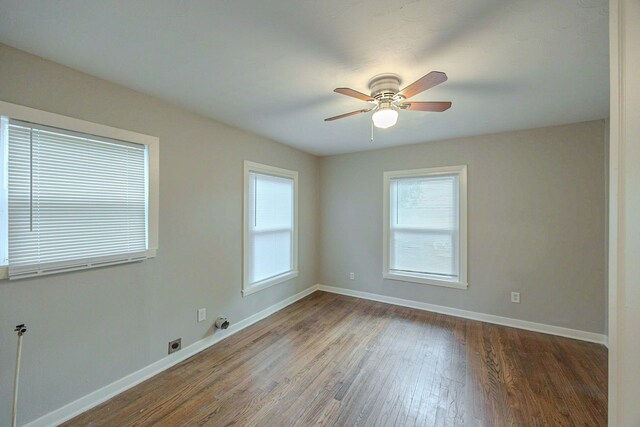 1202 14th Ave N, Texas City, TX 77590 - empty room featuring ceiling fan and dark hardwood / wood-style floors