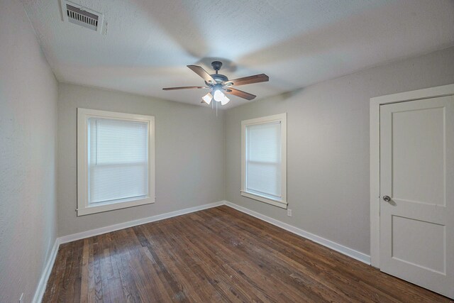 1202 14th Ave N, Texas City, TX 77590 - empty room featuring ceiling fan, dark wood-type flooring, and a textured ceiling