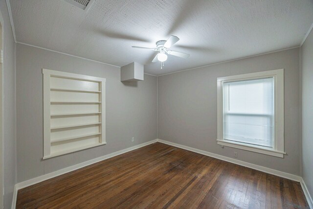 1202 14th Ave N, Texas City, TX 77590 - unfurnished room featuring built in shelves, a textured ceiling, dark hardwood / wood-style flooring, and ceiling fan