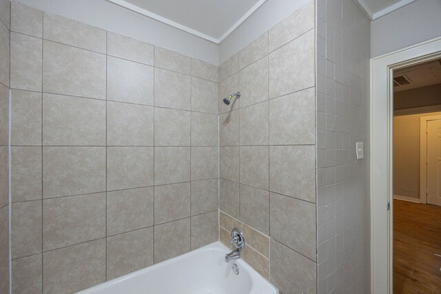 1202 14th Ave N, Texas City, TX 77590 - bathroom with crown molding, wood-type flooring, and tiled shower / bath