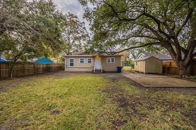 1202 14th Ave N, Texas City, TX 77590 - rear view of property with a yard, a patio, and a storage unit