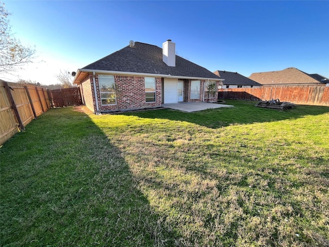 rear view of house with a patio and a yard