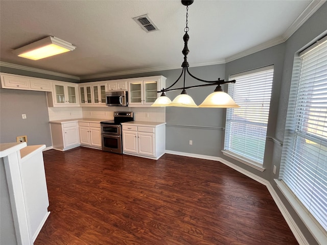 kitchen featuring stainless steel appliances, pendant lighting, and white cabinets