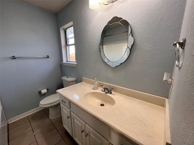 bathroom with vanity, tile patterned flooring, and toilet