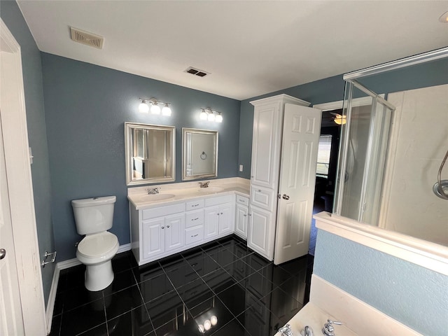 bathroom with vanity, tile patterned floors, toilet, and walk in shower