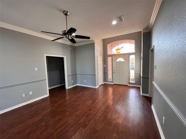 foyer featuring crown molding, dark hardwood / wood-style floors, and ceiling fan