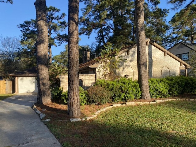 view of property exterior featuring an outbuilding and a garage