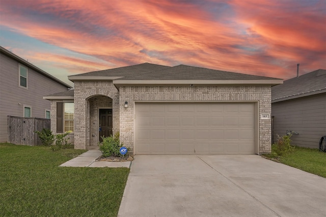 view of front facade featuring a lawn and a garage