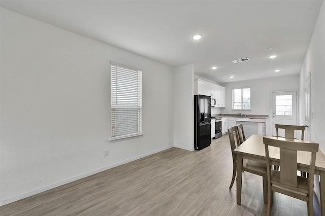 dining room with light wood-type flooring