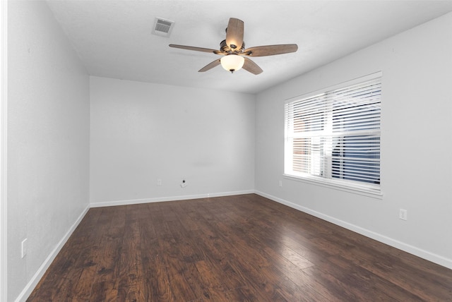 spare room featuring ceiling fan and dark hardwood / wood-style floors