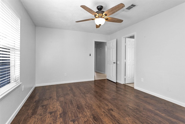 spare room featuring ceiling fan and dark hardwood / wood-style floors