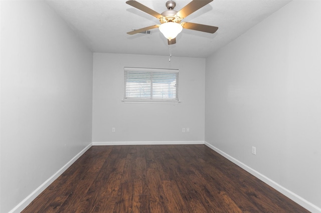 spare room featuring ceiling fan and dark hardwood / wood-style flooring