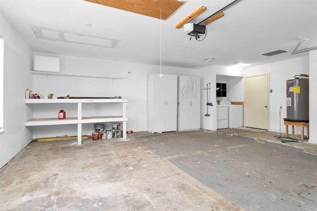 garage with electric water heater, a garage door opener, and washer and clothes dryer