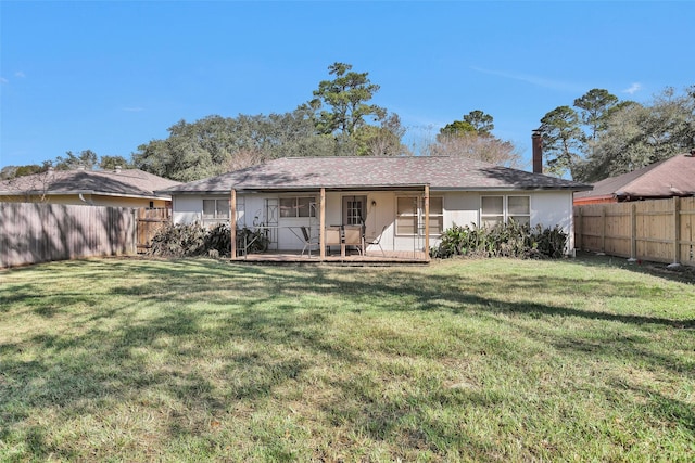 rear view of property featuring a lawn and a patio