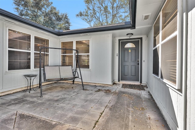 entrance to property featuring a patio