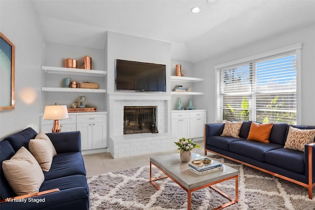 tiled living room with built in shelves, a fireplace, and vaulted ceiling