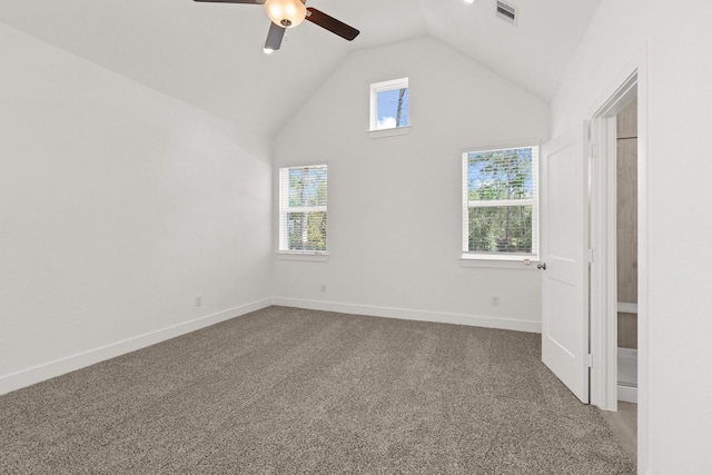 carpeted spare room featuring vaulted ceiling and ceiling fan