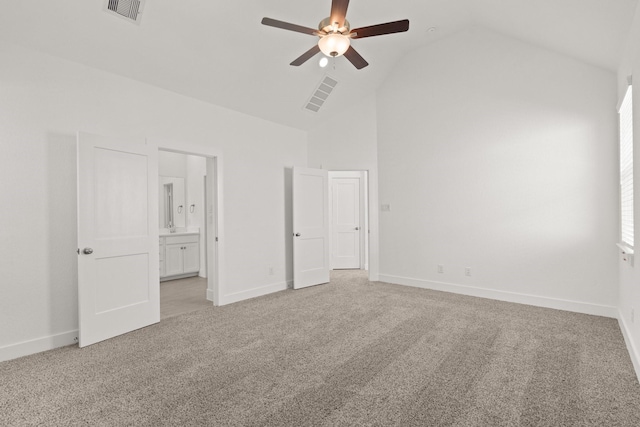 unfurnished bedroom with connected bathroom, light colored carpet, ceiling fan, and lofted ceiling